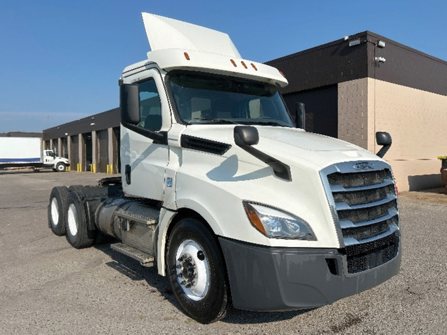 Freightliner Cascadia 126 tractor cab in white, side view, no trailer attached.