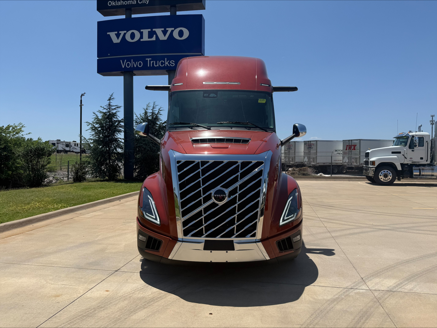 Volvo VNL64T860 truck front view in showroom lot showing signature grille and headlights.