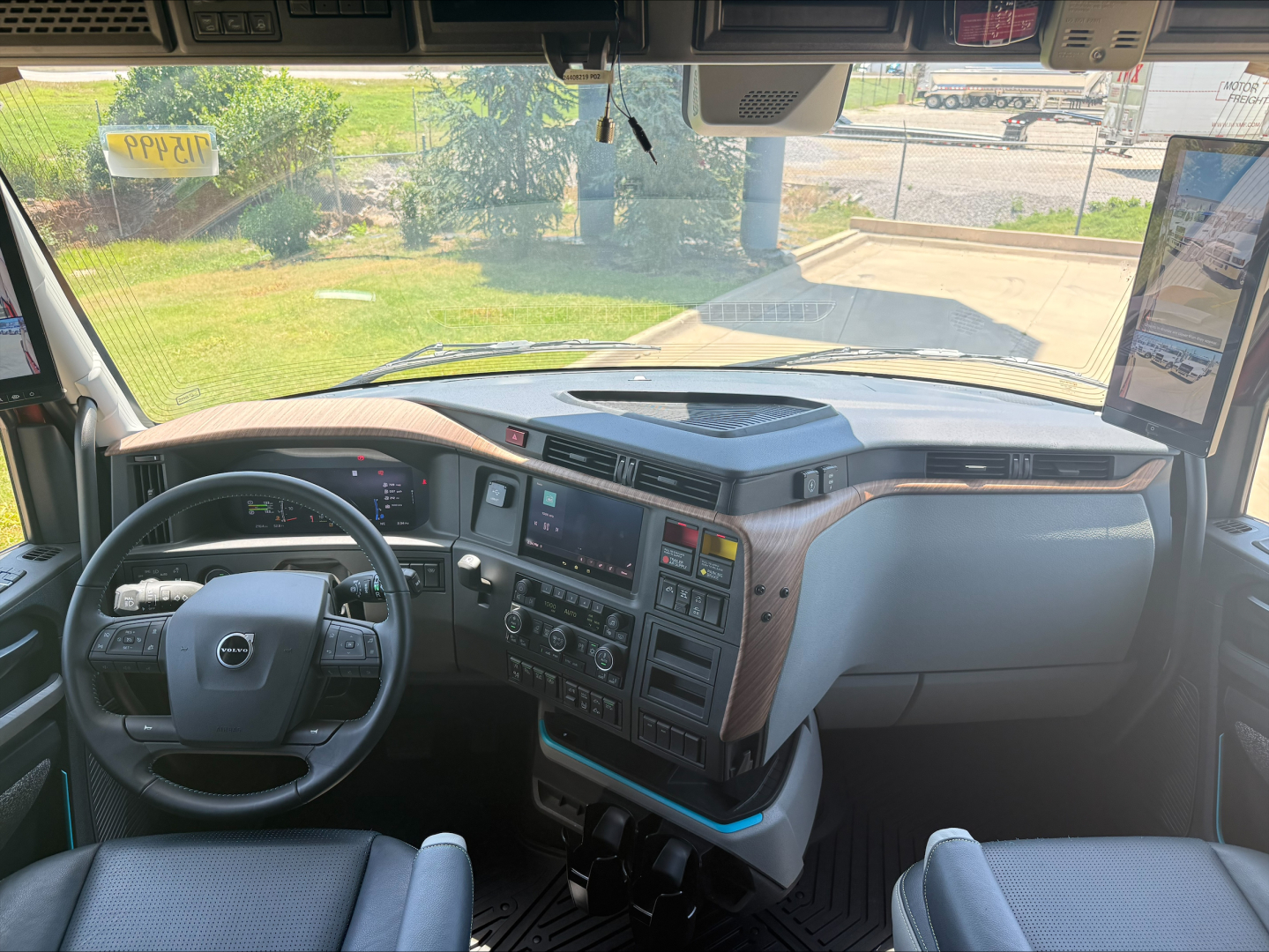 Volvo VNL64T860 truck interior dashboard and steering wheel with digital displays and controls visible.