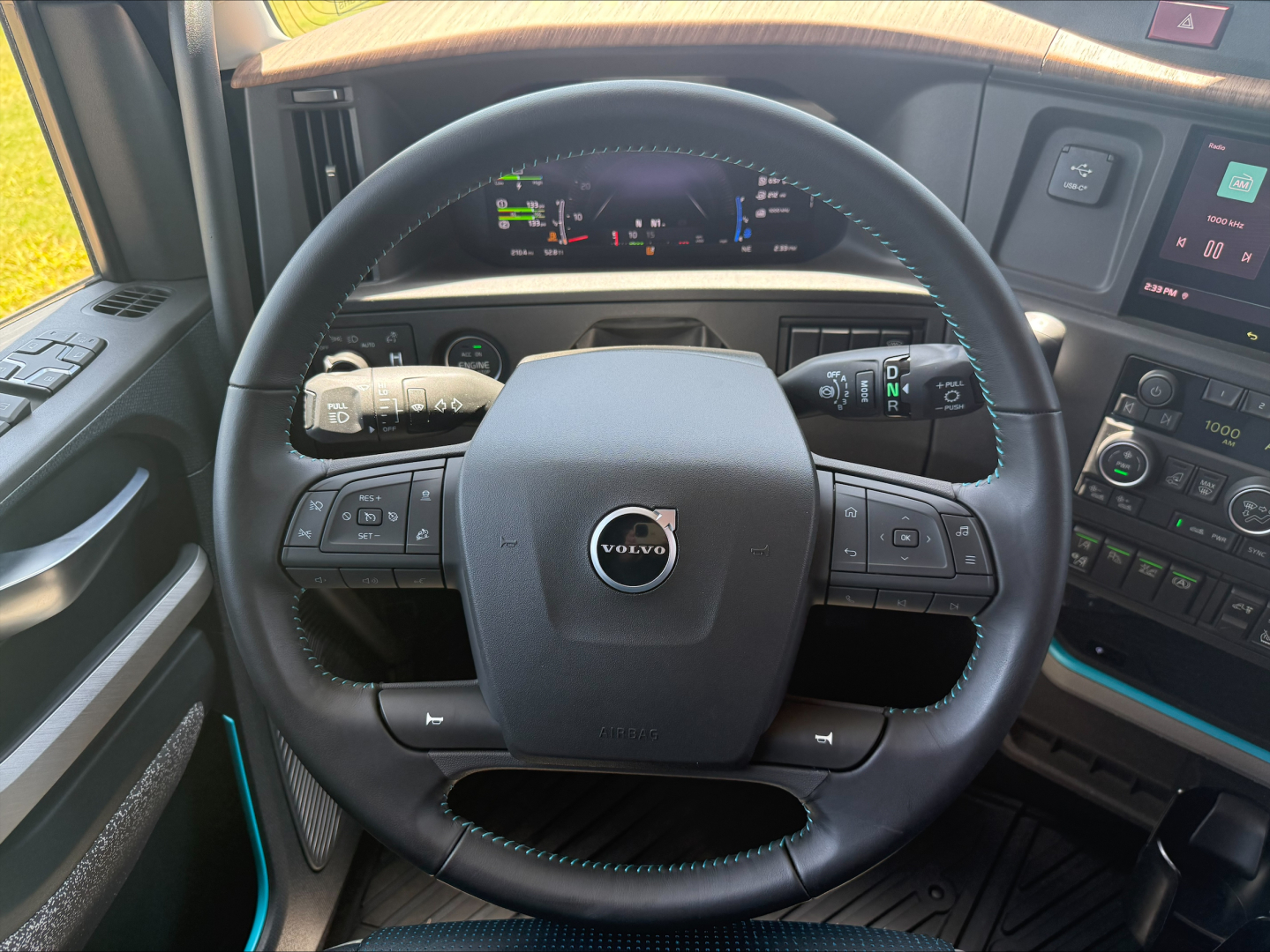Volvo VNL64T860 interior view of steering wheel and dashboard with digital gauges and control stalks.