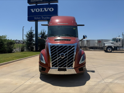 Volvo VNL64T860 truck front view in showroom lot showing signature grille and headlights.