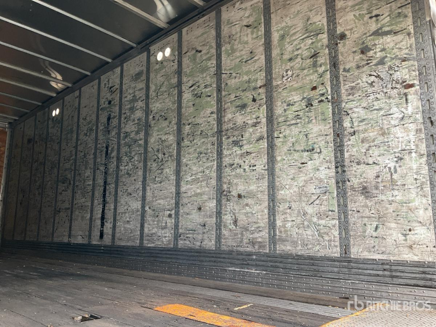 Trailer interior showing metal framing and plywood wall sheathing inside a Wabash DVDBHPC trailer.