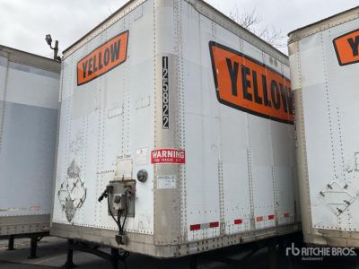 Trailer rear showing YELLOW branding and hazard placards on a Wabash DVDBHPC trailer