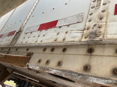 Wabash trailer side showing riveted metal skin and rust-free hardware with reflective tape.