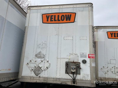 Rear view of a trailer with a large orange 'YELLOW' label on the door, including a PDE hitch and warning decals.