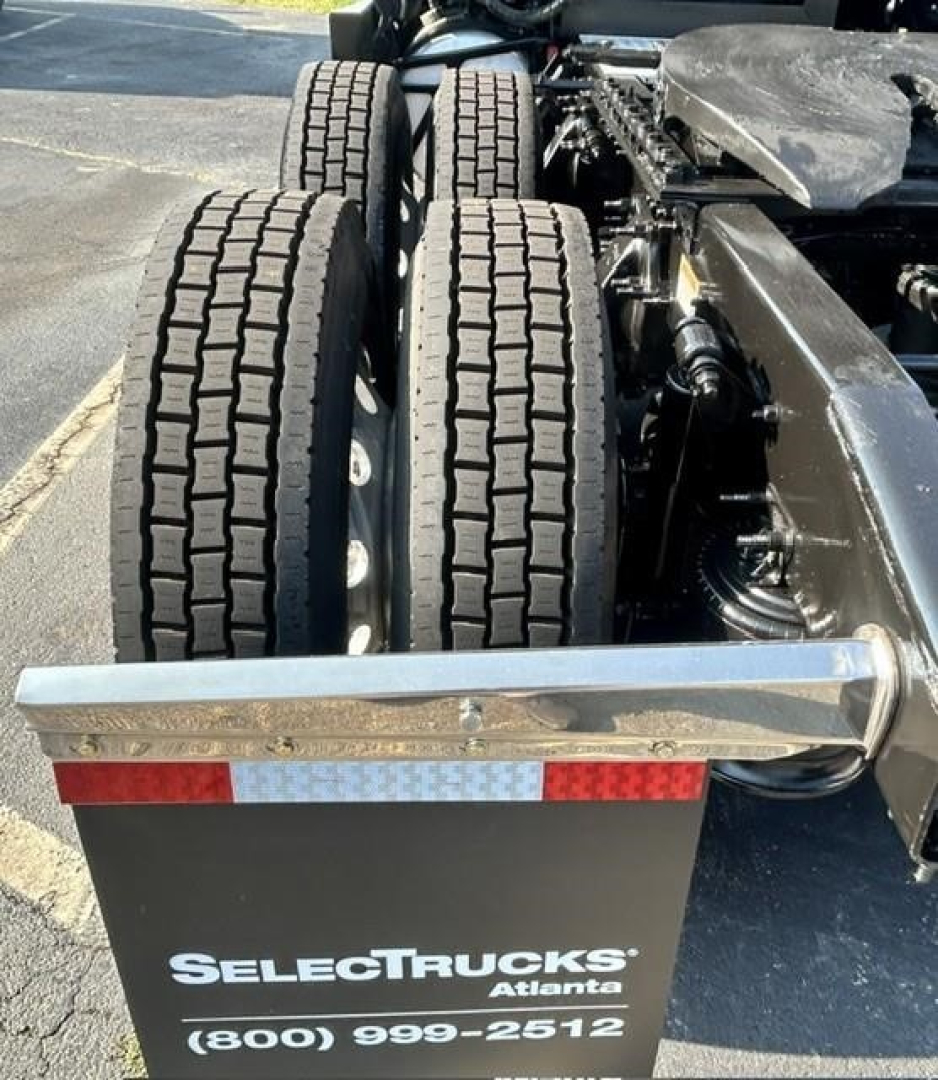 Freightliner Cascadia 126 rear wheels and chassis showing dual rear axles and.SelectTrucks Atlanta branding plate