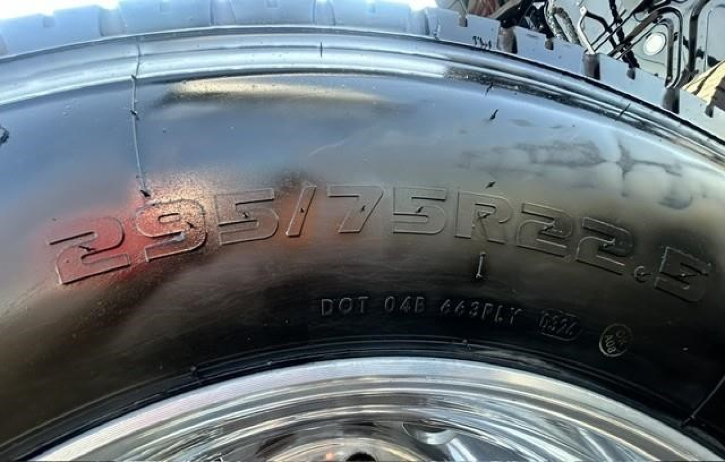 Tire close-up showing size 295/75R22.5 on a Freightliner Cascadia 126 sleeper cab wheel.