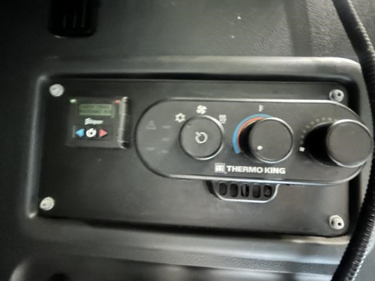 In-cab control panel for Thermo King auxiliary heater with knobs and vents visible.