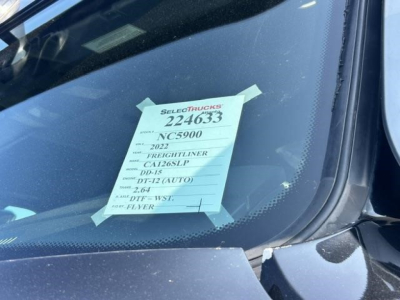 Truck windshield tag with listing details on a 2022 Freightliner Cascadia: VIN 3AKJHHDR3NSNC5900, stock 224633, category conventional sleeper, model DT15? (text on tag).
