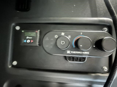 In-cab control panel for Thermo King auxiliary heater with knobs and vents visible.