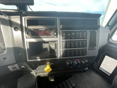 Mack MD7 truck cab dashboard showing radio, control switches, and climate dials.
