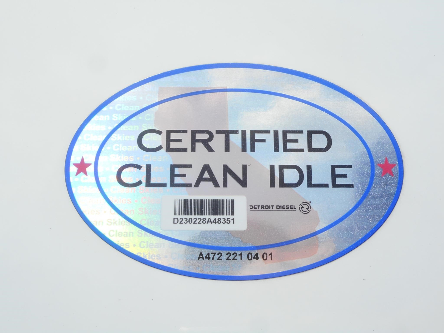 Sticker reading CERTIFIED CLEAN IDLE with barcode and Detroit Diesel branding on a white surface.