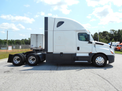 Freightliner Cascadia 126 tractor truck side view showing sleeper cab and dual rear axles.