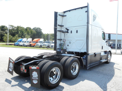 Rear and side view of a Freightliner Cascadia 126 semi-truck tractor showing the fifth-wheel area and dual rear axles.
