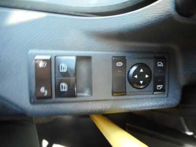 Freightliner Cascadia interior control panel with multiple switch buttons and a circular joystick-style control knob.