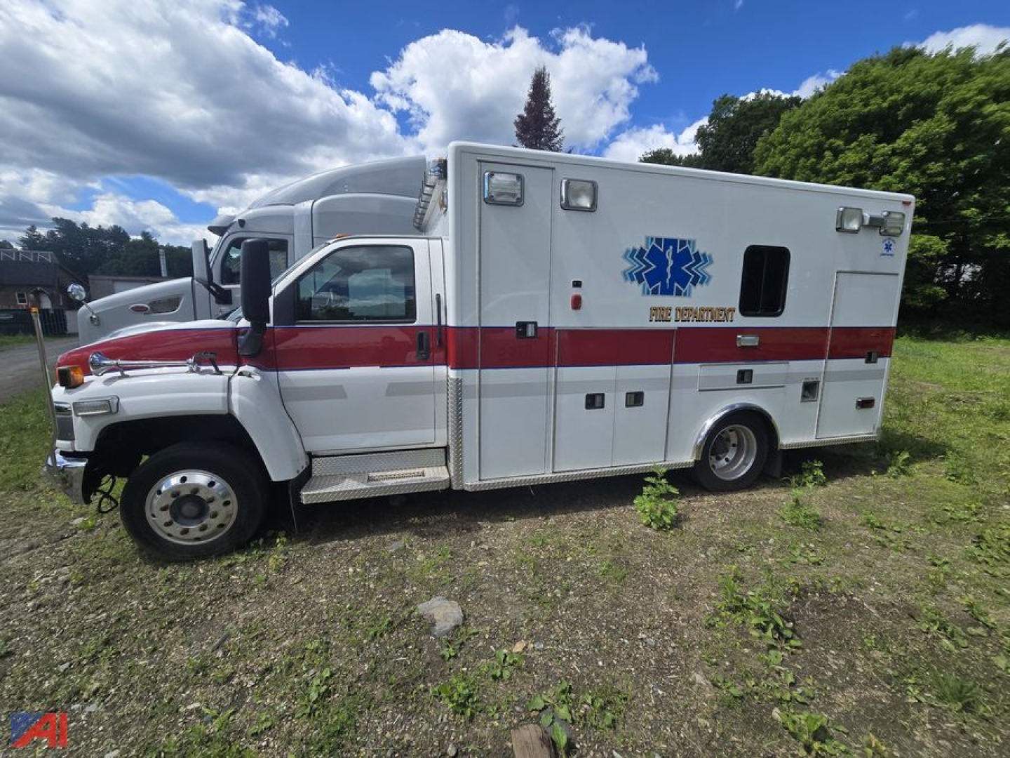 Ambulance side view showing 2007 Chevrolet Kodiak C4500 with red stripe and Star of Life emblem, multiple compartments, and rear ambulance body.