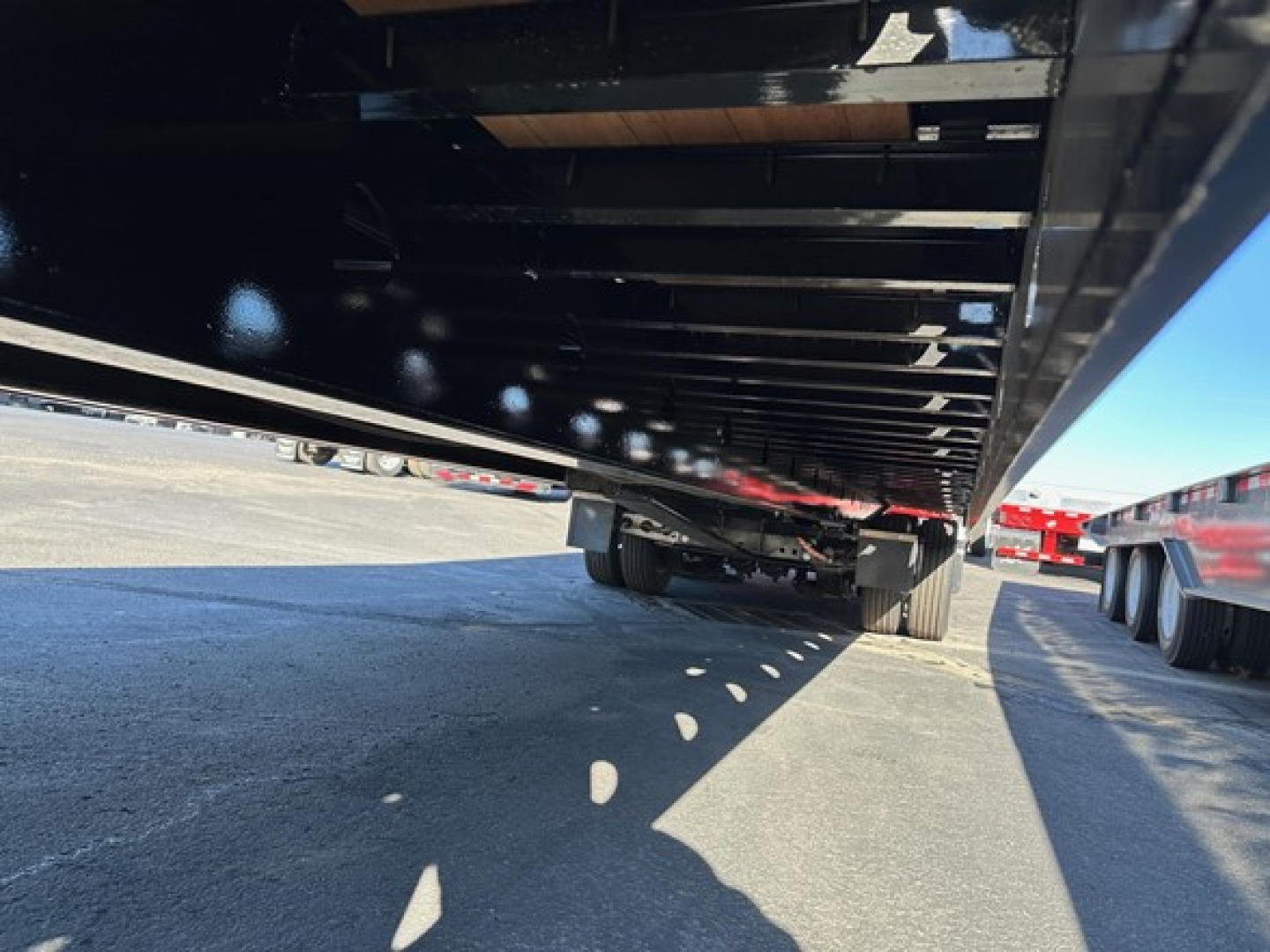 Trailer axle assembly underside with air ride system and winch mounting visible, Doepker 40 ton slide axle trailer.