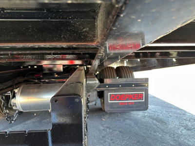 Doepker trailer wheel area showing 40-ton slide axle with air ride and Winch box labeled 'DOEPKER' under the trailer.
