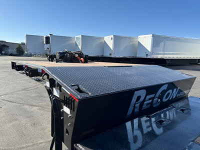 Doepker 40 ton slide axle trailer with 20K winch and air ride showing deck and wheel area