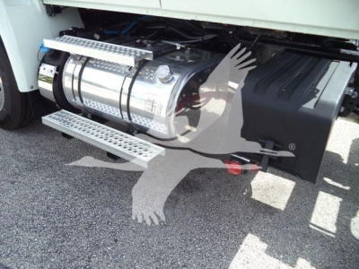 Truck fuel tank and side components under the cab of a 2027 International MV rollback truck showing polished cylindrical fuel tank and side steps.