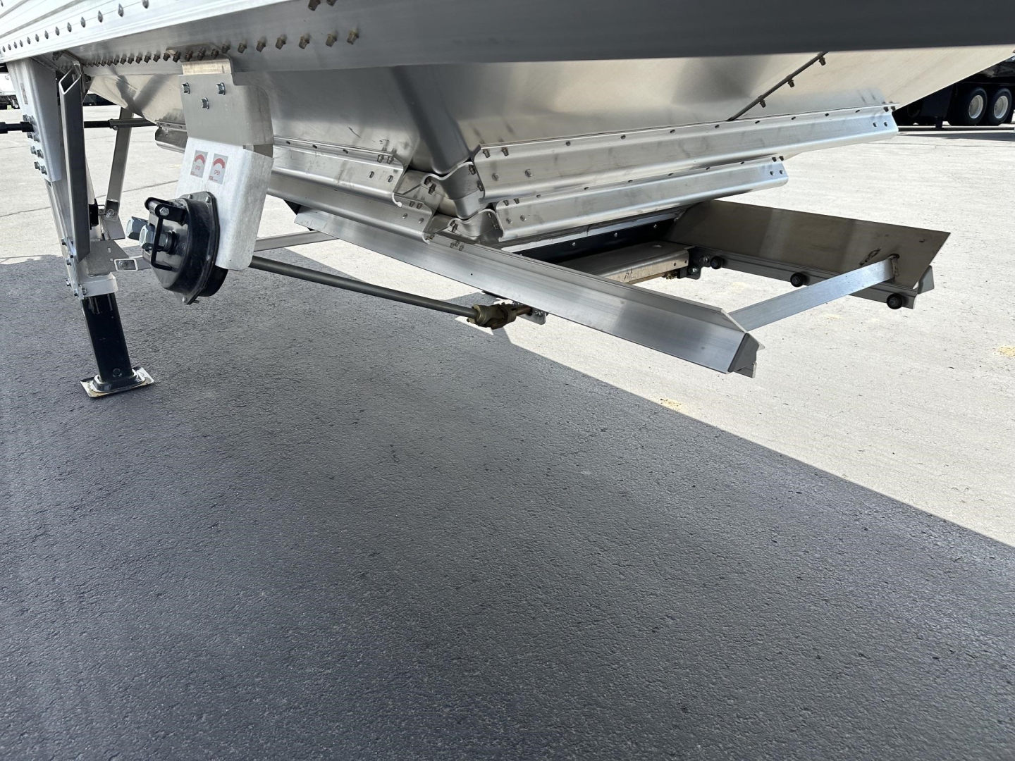 Trailer hitch area of a new Timpte hopper trailer showing undercarriage and support structure.