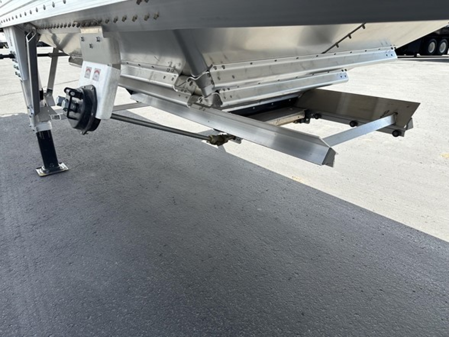 Trailer underside showing adjustable landing gear and hitch area of a new Timpte Super Hopper Tri Axle