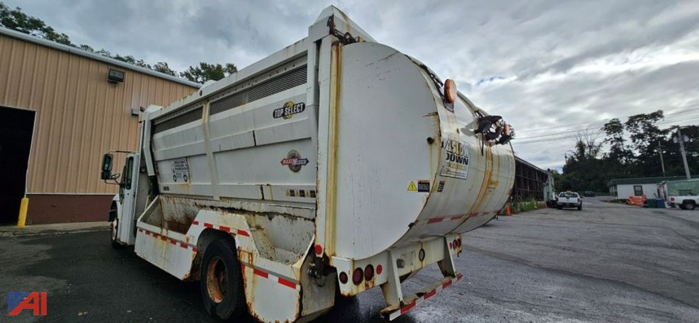 Rear/side view of a white 2007 International SA625 WorkStar 7400 dump truck with rust and dirt, showing back of dump body, taillights, and rear hitch.