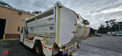 Rear/side view of a white 2007 International SA625 WorkStar 7400 dump truck with rust and dirt, showing back of dump body, taillights, and rear hitch.