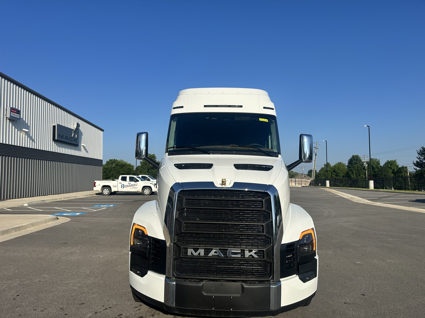 Mack PR64T76M cab facing front showing grille with MACK letters and large black air intake