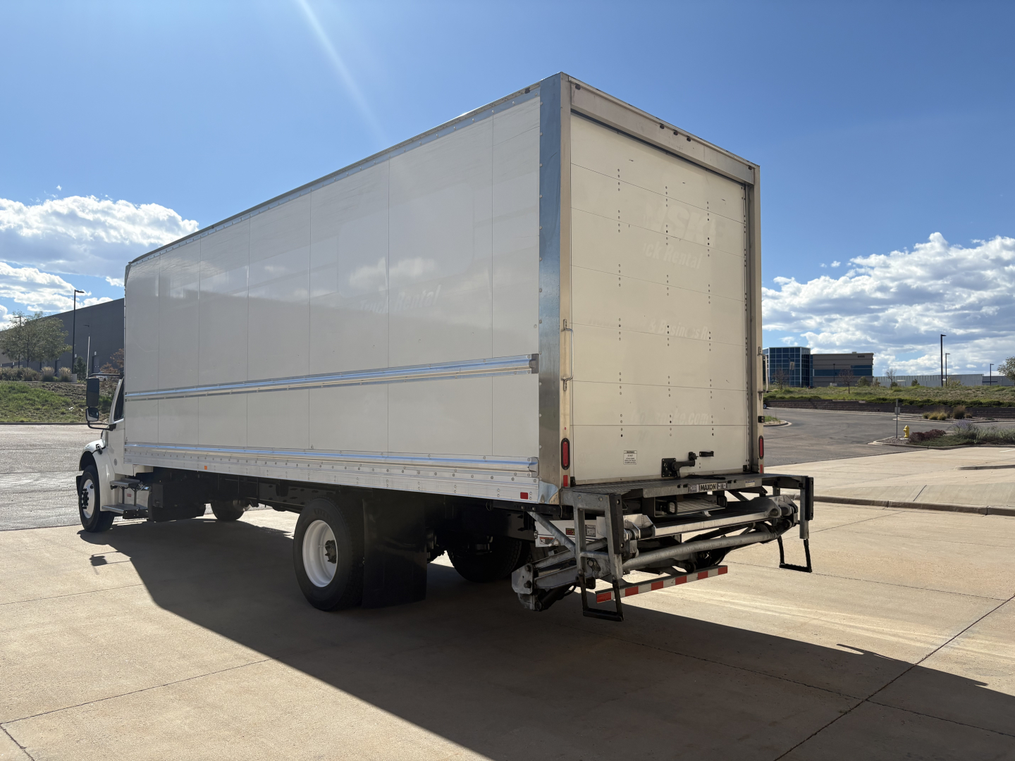 Freightliner M2-106 box truck rear and left-side view showing box cargo area and rear bumper.