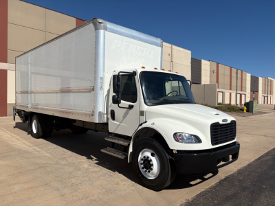 Truck side view showing 2022 Freightliner M2-106 box truck with white cab and aluminum cargo box.