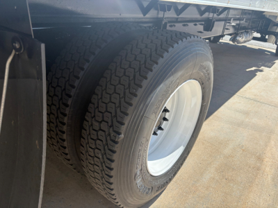 Freightliner M2-106 wheel and dual rear tires showing white rim and black tire tread.