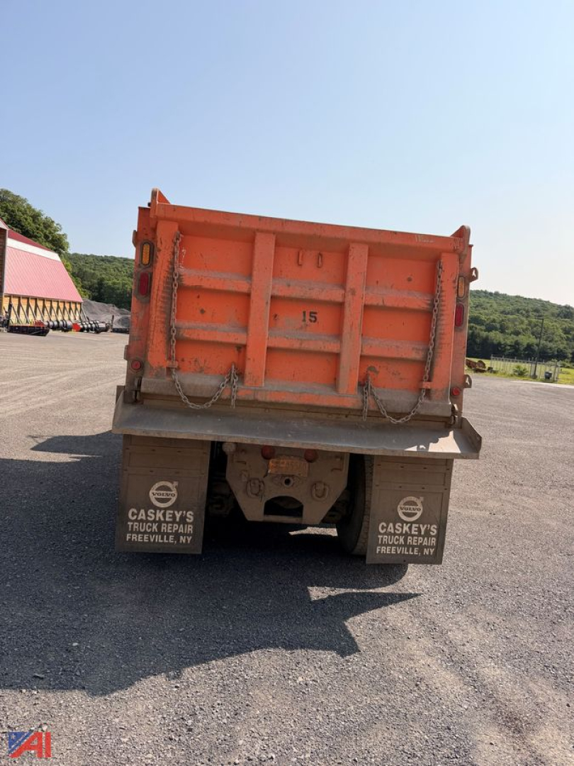 Dump truck bed showing rear view of an orange dump body with chains and bumper, mudflaps read Caskey's Truck Repair Freeville NY.