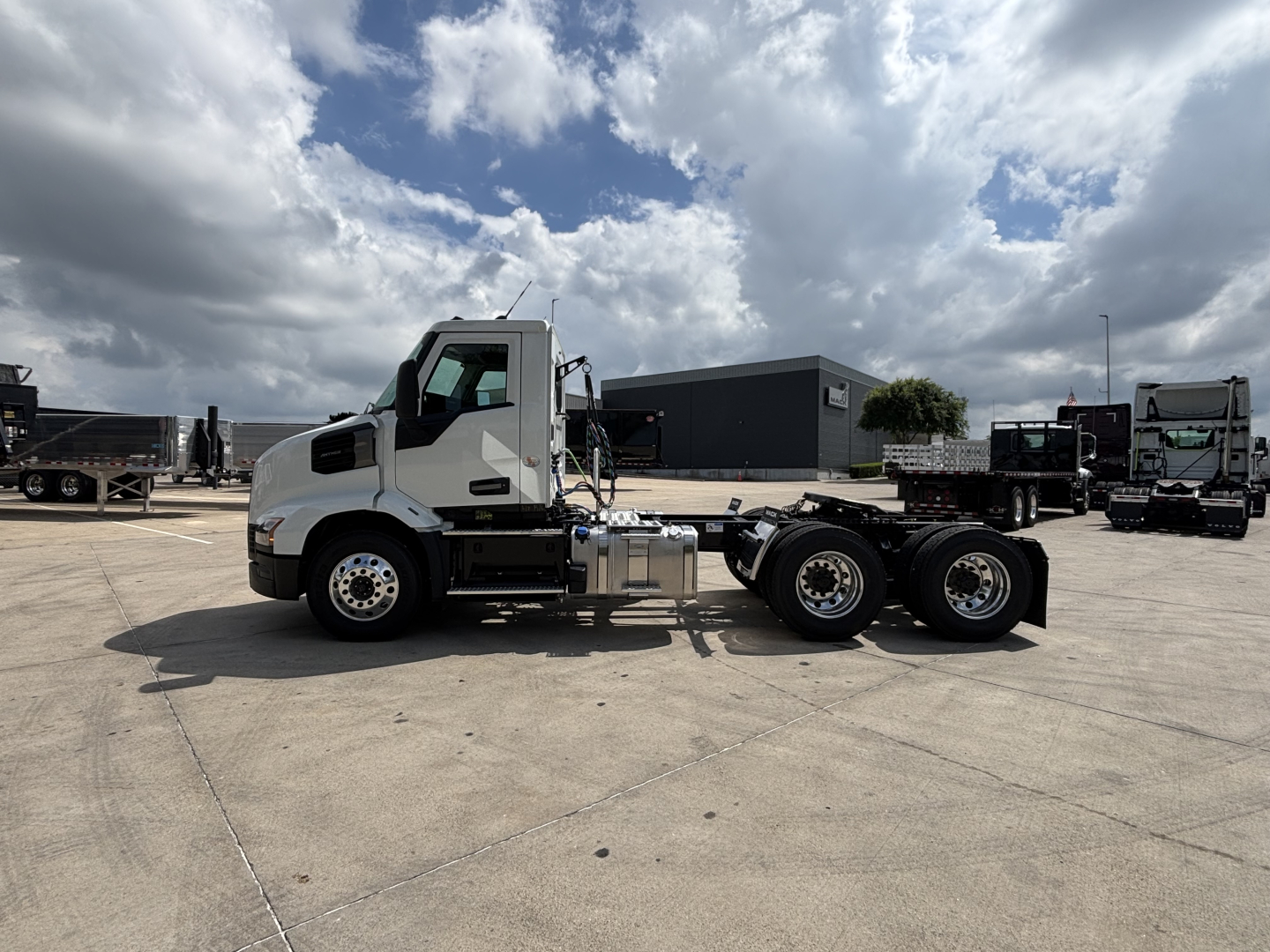 New 2027 Mack AN64T daycab truck side view showing front cab, chassis, and rear axles.