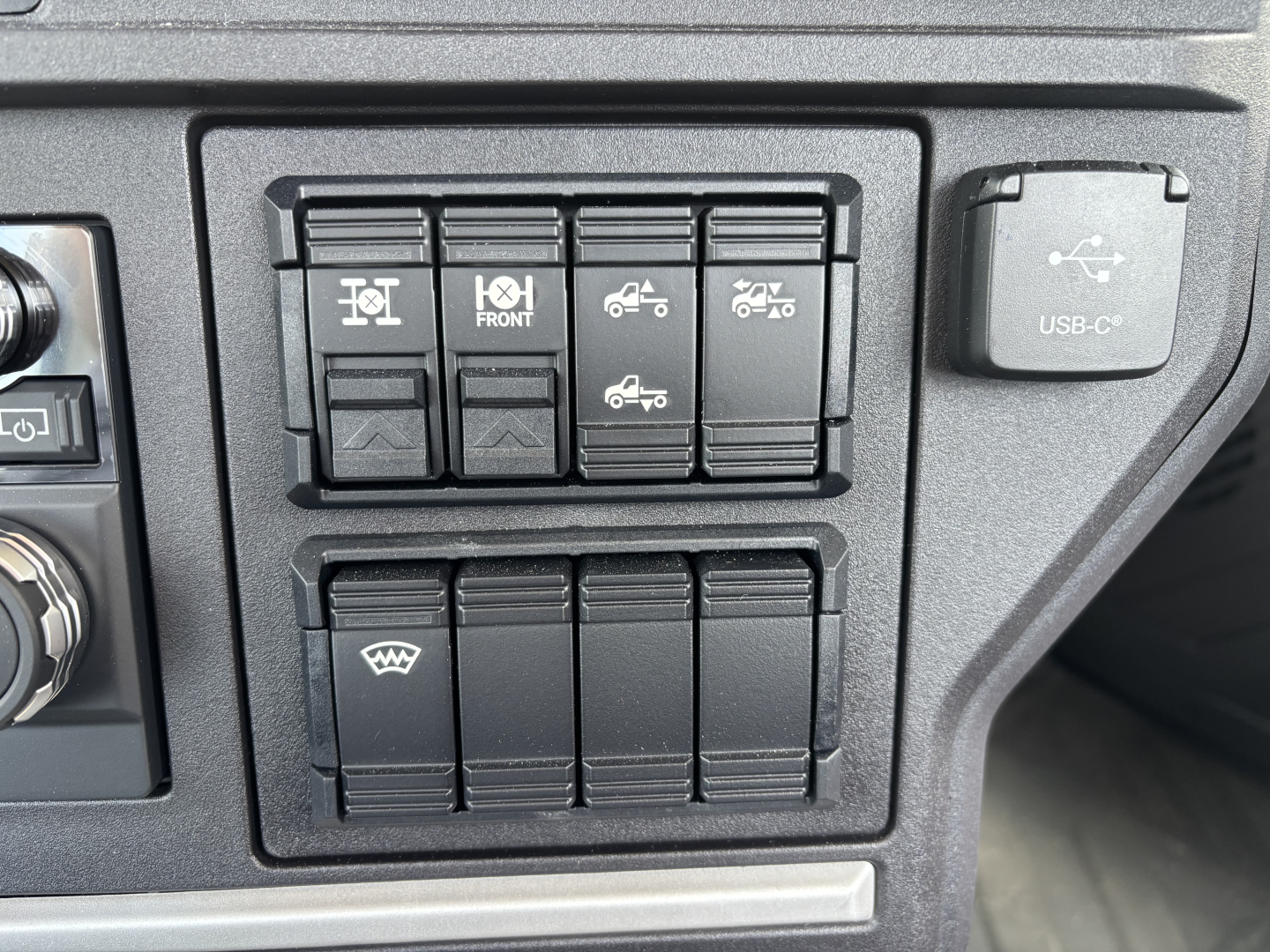 Dashboard switch panel with multiple rocker switches and a USB-C port visible on the right.