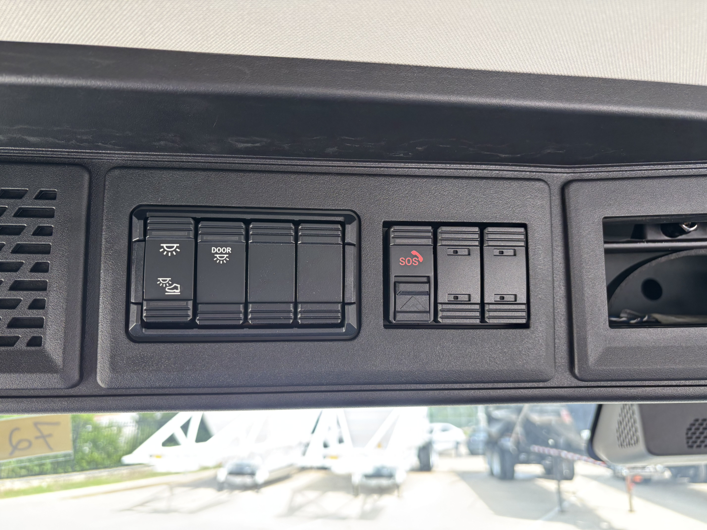 Dashboard switches panel with multiple rocker switches and labeled buttons visible in cab interior.