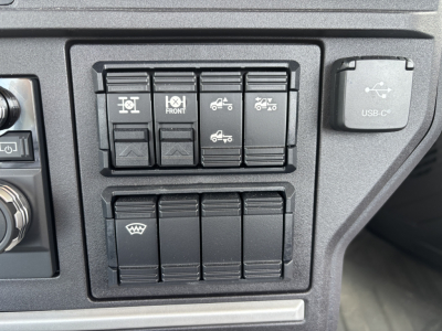 Dashboard switch panel with multiple rocker switches and a USB-C port visible on the right.
