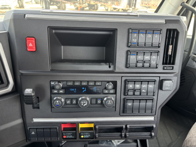 Interior dashboard of a 2027 Mack AN64T showing instrument cluster, climate controls, and switch panels.