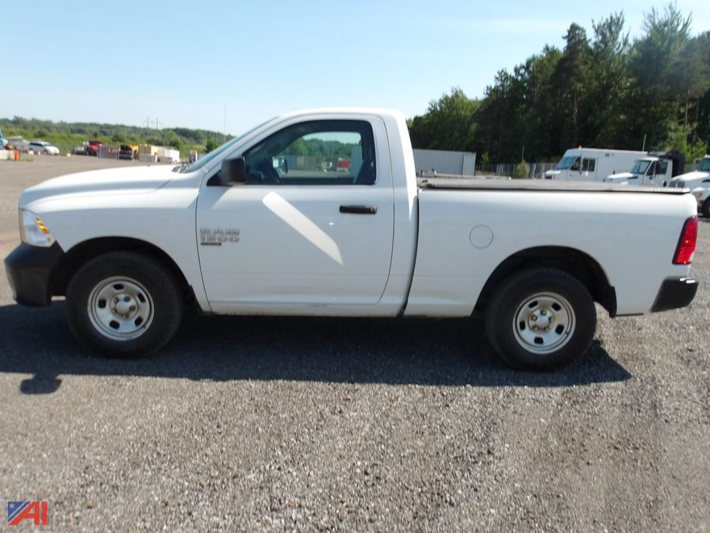Ram 1500 Classic single cab pickup truck side view in white parked on gravel.
