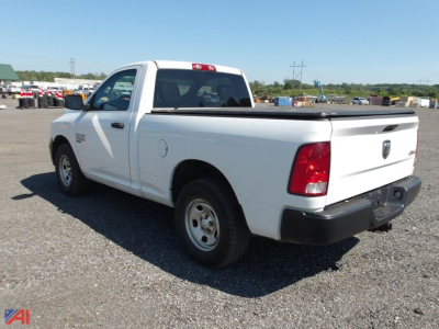 White Ram 1500 Classic pickup truck in a gravel lot, rear three-quarter view, short bed, 2-door regular cab, 4x4 badge on side.