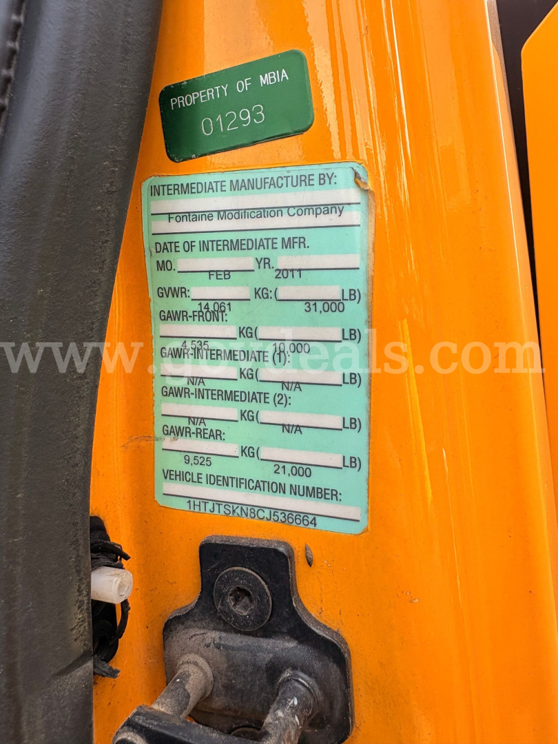 Green and white vehicle identification sticker on an orange truck door shows property of MBIA 01293, Intermediate Manufacturer by Fontaine Modification Company, Date of Intermediate MFR MO. FEB 2011, GVWR 14,600 LB, GAWR FRONT 7,000 LB, GAW
