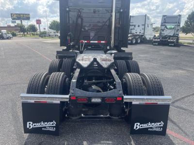 Rear view of a Volvo VNL64T660 tractor chassis showing dual rear axles, fifth wheel, and mud flaps labeled 'Bruckners Truck Equipment' with reflectors and license-plate area.