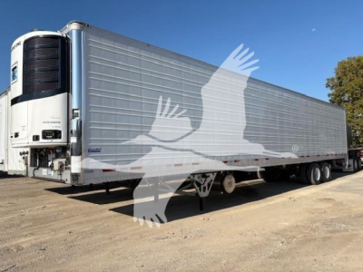 Reefer trailer in service with silver side panels and large refrigeration unit at front, Vanguard R8000B model visible.