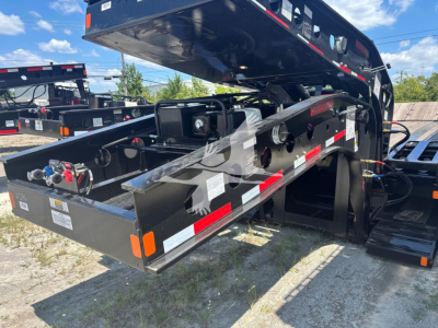  Fontaine Renegade N12 lowboy trailer deck with hydraulic system and control components, tags, and warning decals visible.