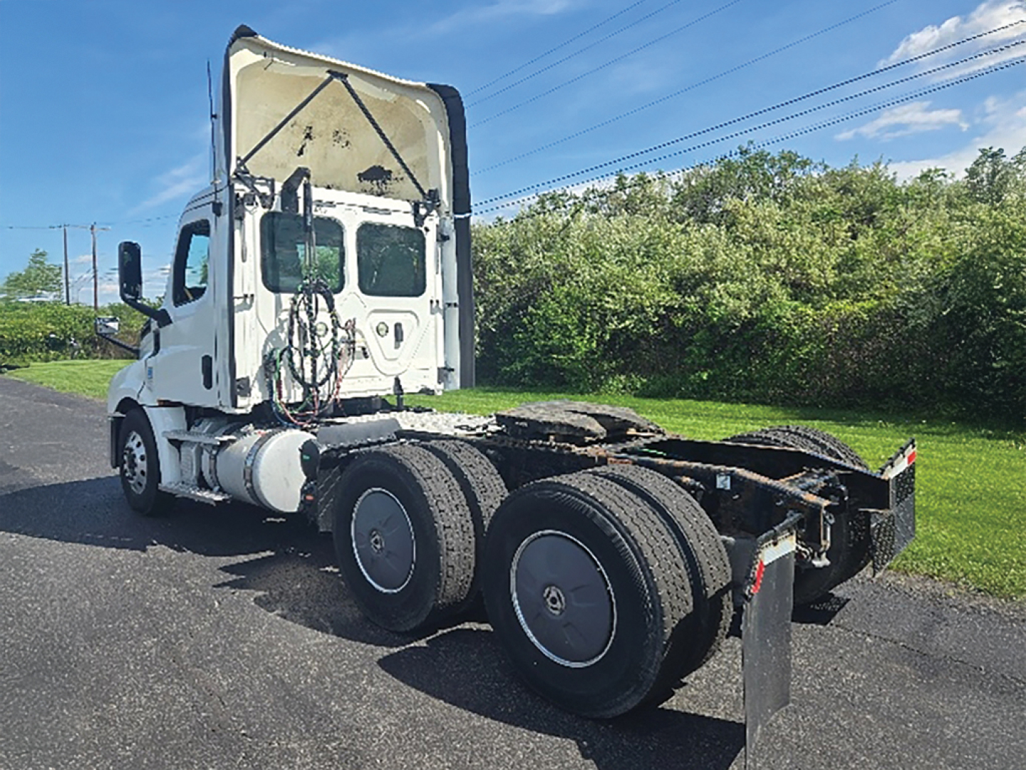Truck cab with rear chassis showing fifth wheel area and dual rear axles of a Freightliner Cascadia126. VIN plate not visible in this view.