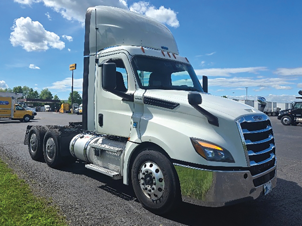 2019 Freightliner Cascadia1125 truck cab with sleeper, side view showing chrome fuel tanks, dual rear axles, and Freightliner styling.
