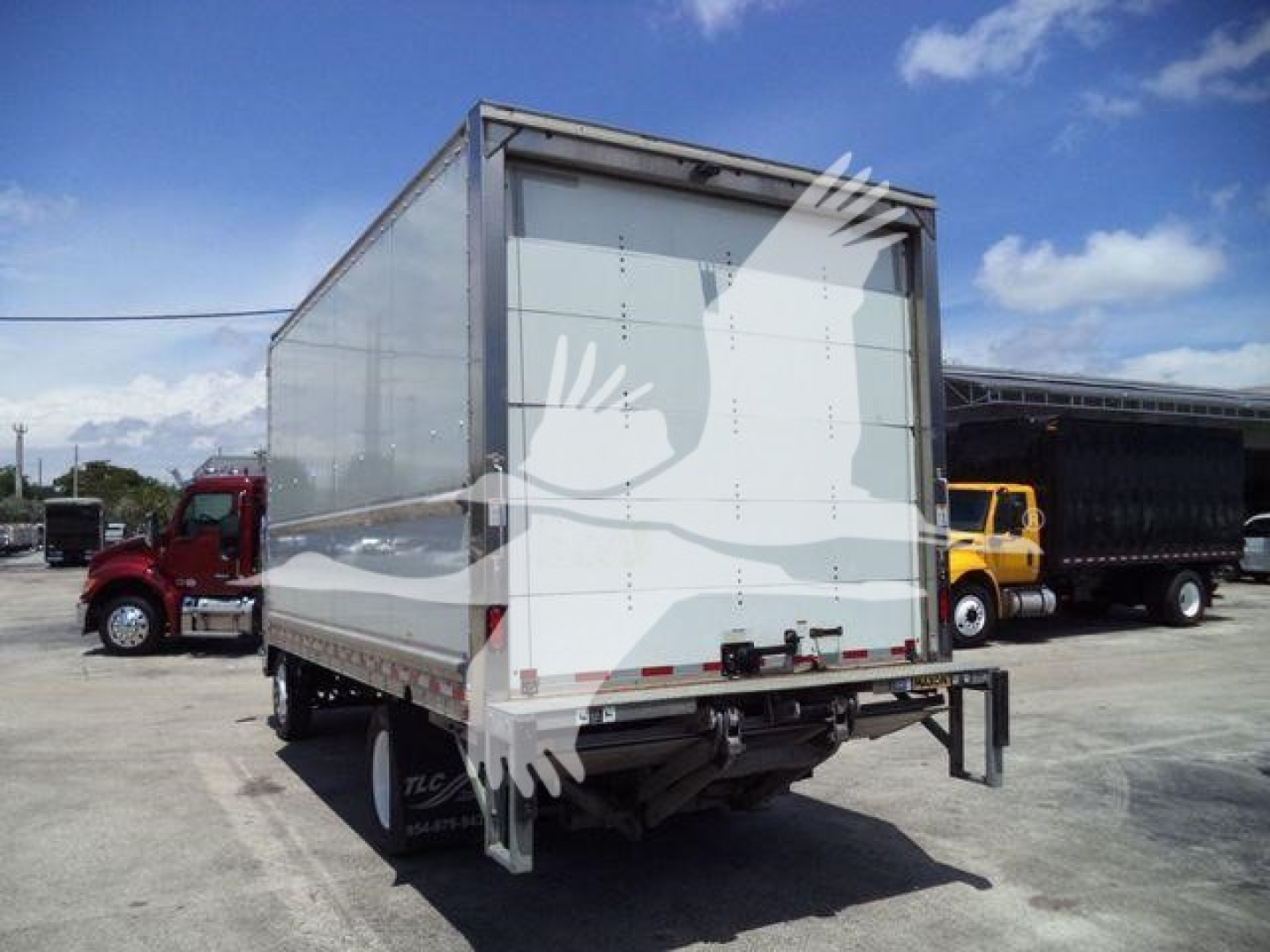 Isuzu NPR-HD box truck rear view showing cargo box and rear underride guard.