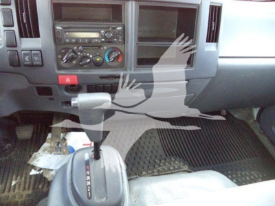 Isuzu NPR HD cab interior showing gear selector and dashboard controls.