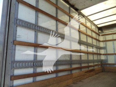 Isuzu NPR HD truck cargo area showing wooden side rails and metal wall beams inside a box truck.