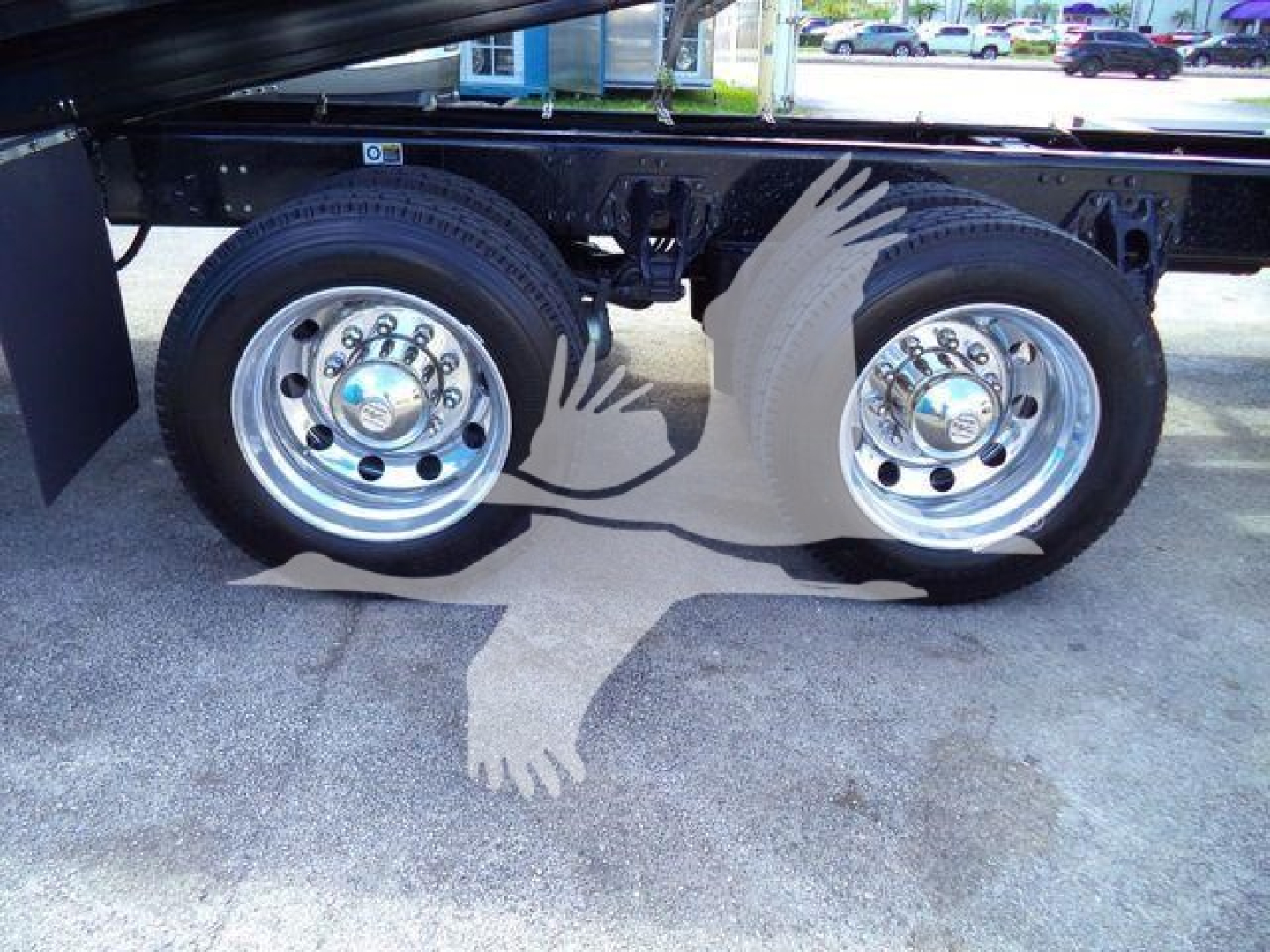 Kenworth T880 truck rear wheels and frame with decorative eagle artwork on the mud flaps area